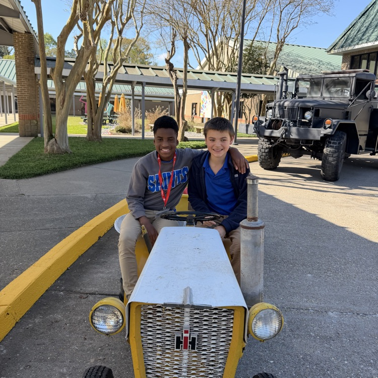 students riding a tractor