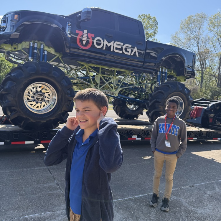 student pictured with a monster truck