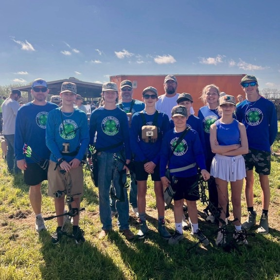 Archery students pose for photo  