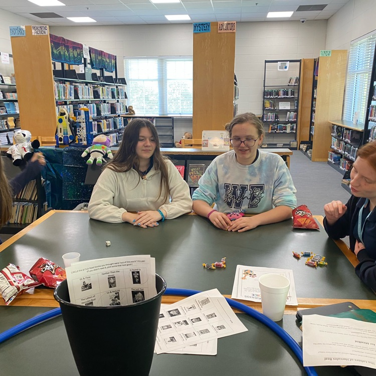 Club Read members seated at table playing a game 