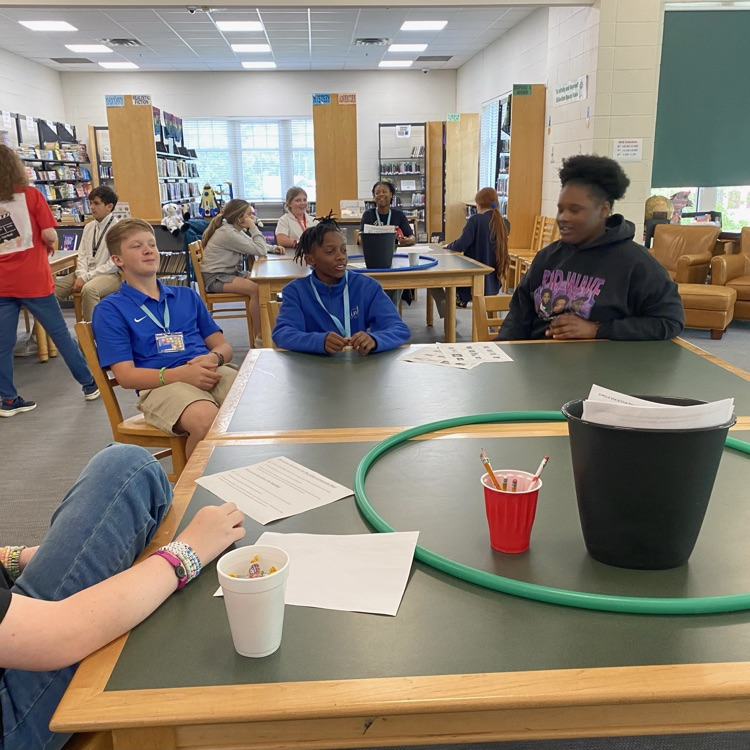 Club Read members seated at table playing a ga
