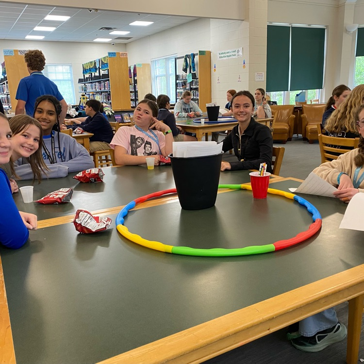 Club Read members seated at table playing a ga