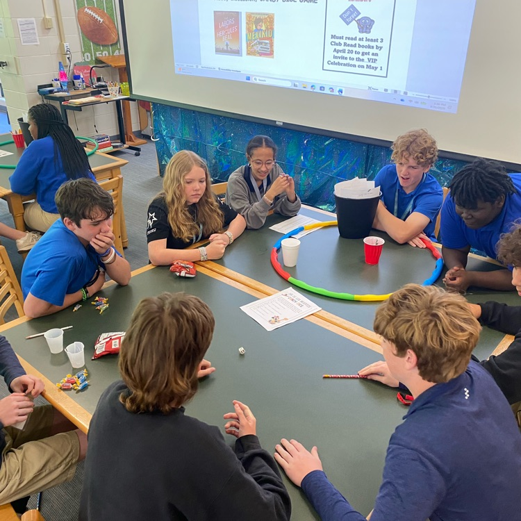 Club Read members seated at table playing a ga