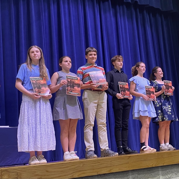 winners of the young authors contest take the stage