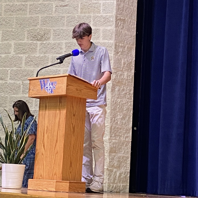 Student reads work at podium