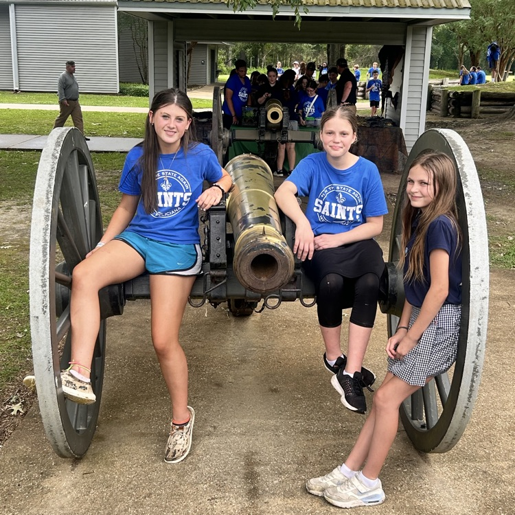 students pictured with cannon