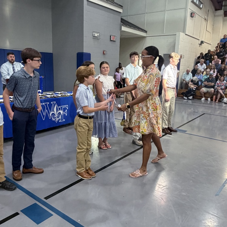 Coach gives athlete a medal