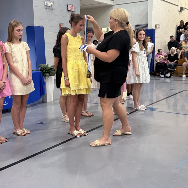 Coach gives athlete a medal