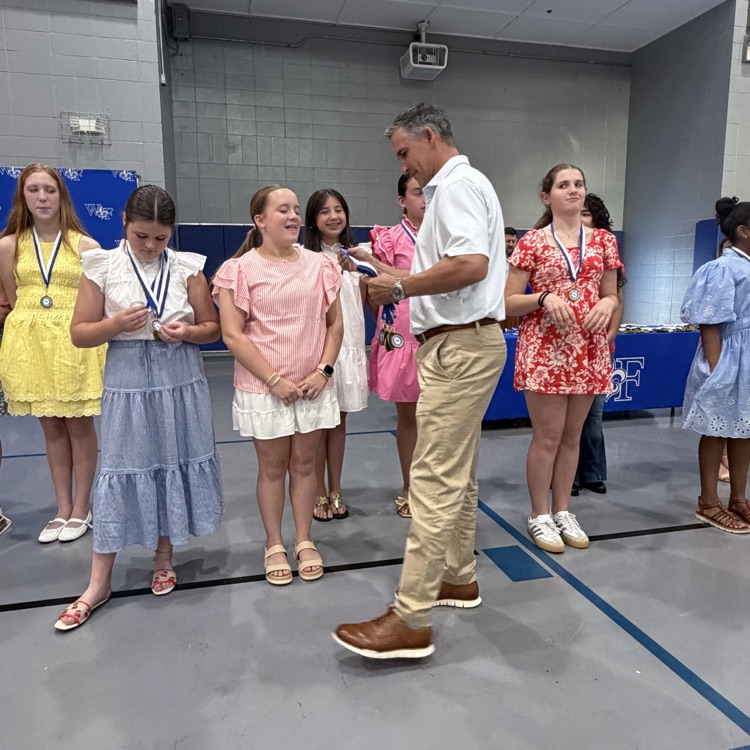 Coach gives athlete a medal