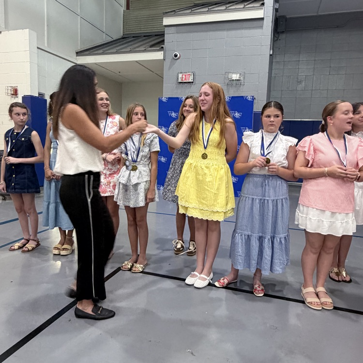 Coach gives athlete a medal