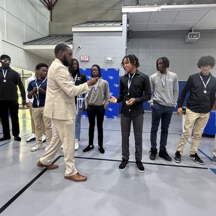Coach gives athlete a medal