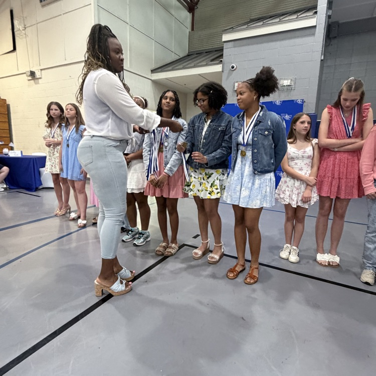 Coach gives athlete a medal