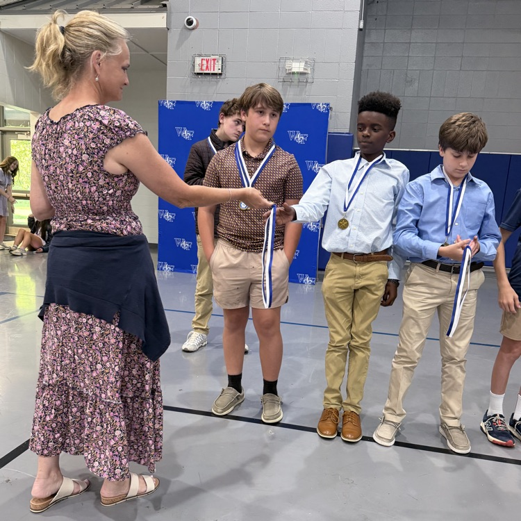 Coach gives athlete a medal