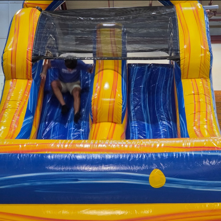student slides on an inflatable slide