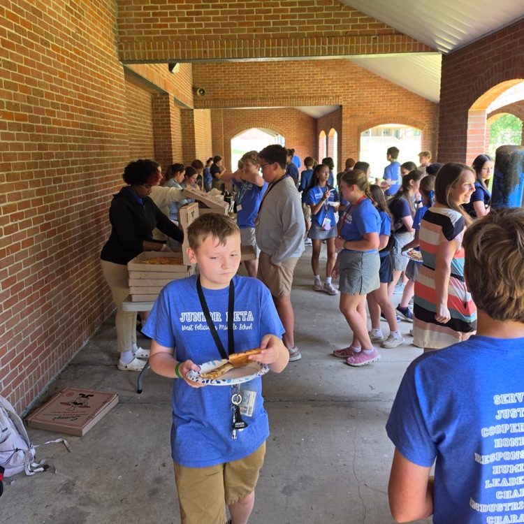 student eating surrounded by lots of other students