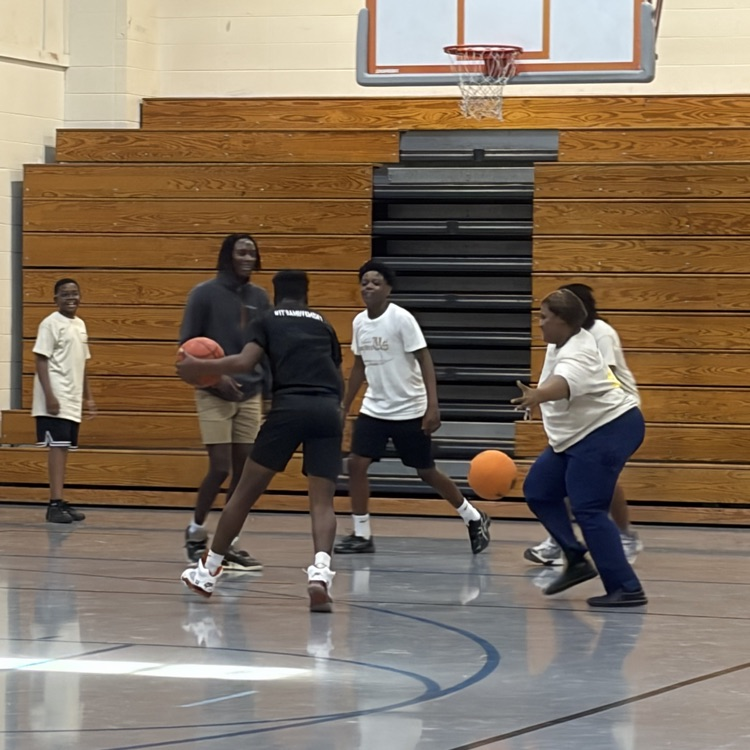 cafeteria staff plays basketball with students