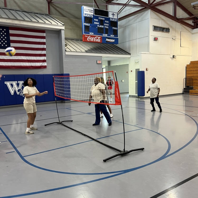 cafeteria staff plays volleyball with students