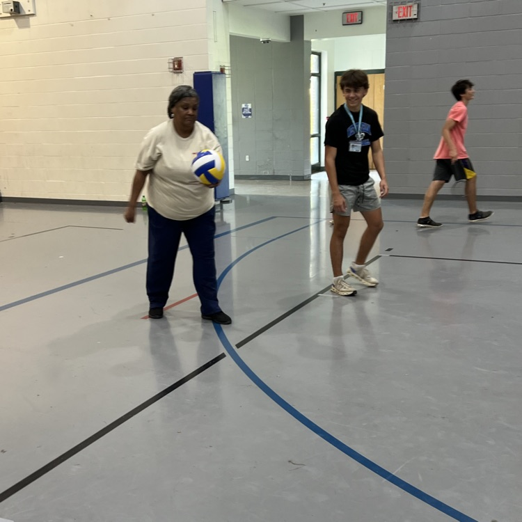 cafeteria staff plays volleyball with students