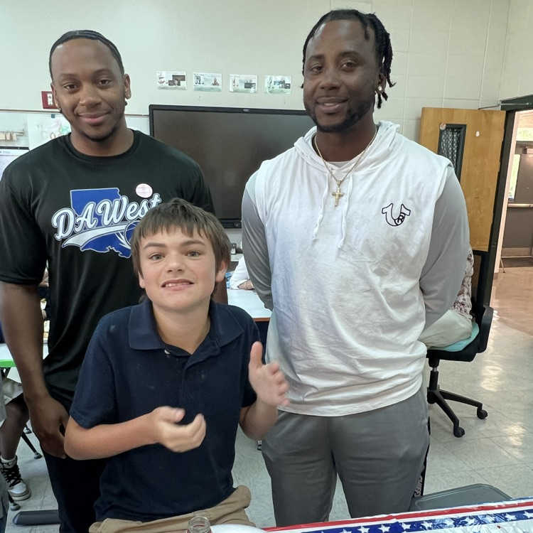 student pictured with 2 teachers 