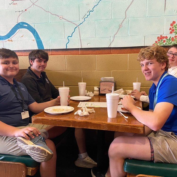 students eat at pizza restaurant