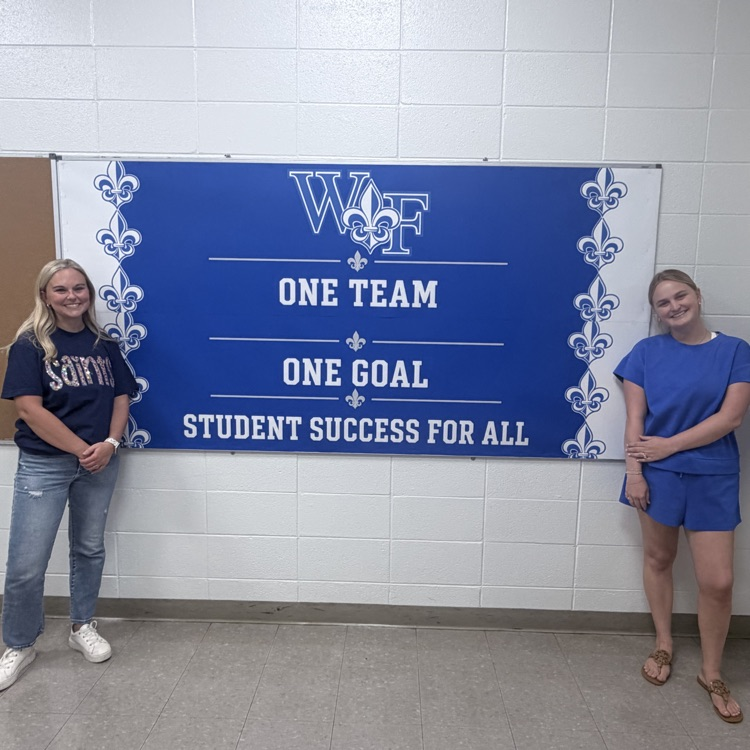 Ms. Williams & Ms. Jones show off their bulletin board design 