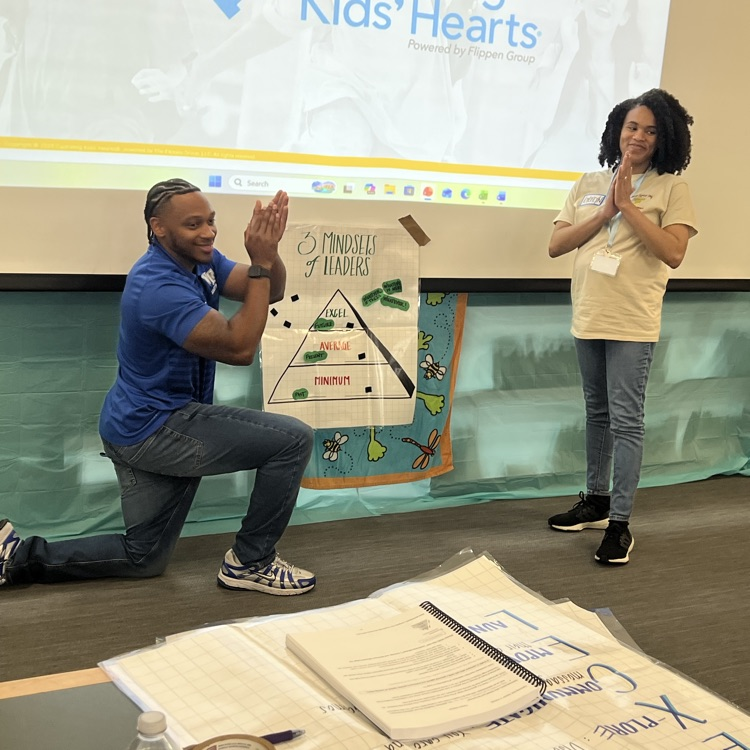 Staff members share a poster