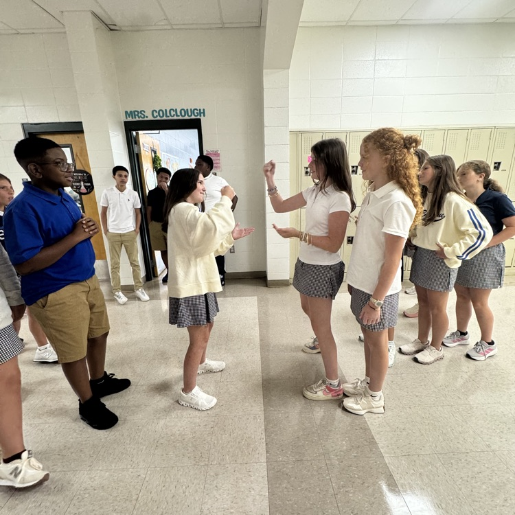 Students play rock, paper, scissors 
