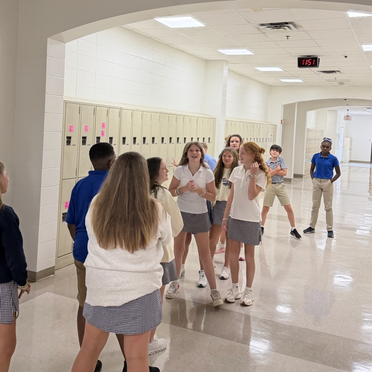 Students play rock, paper, scissors 