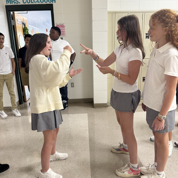 Students play rock, paper, scissors 