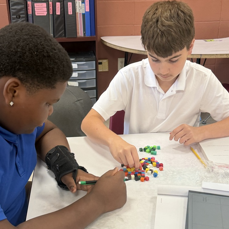 students work with math manipulatives