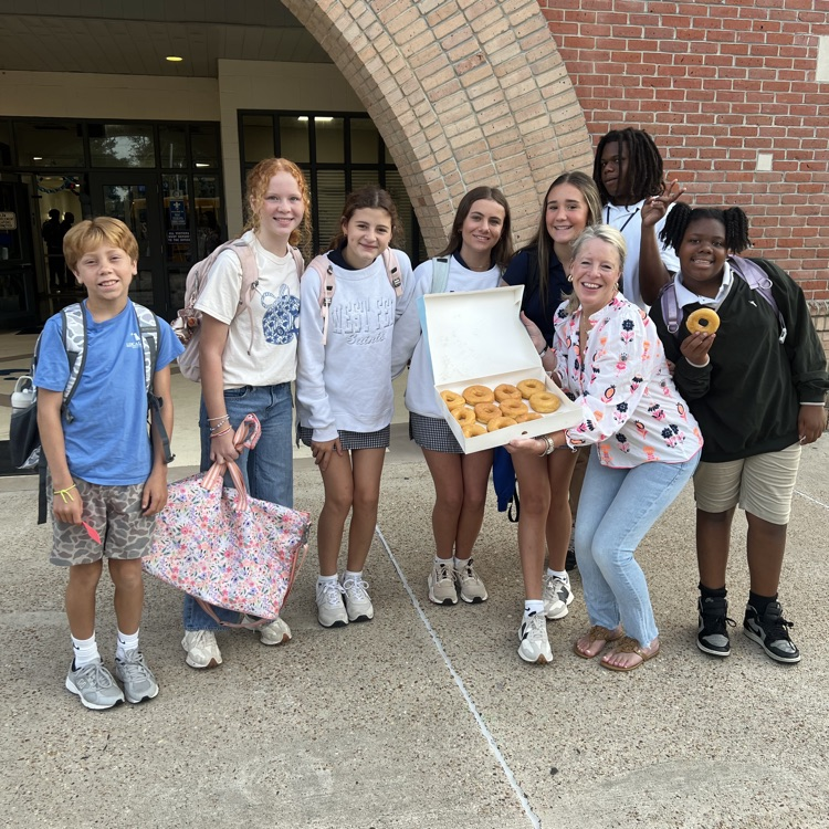 WyldLife leaders pass out donuts to students