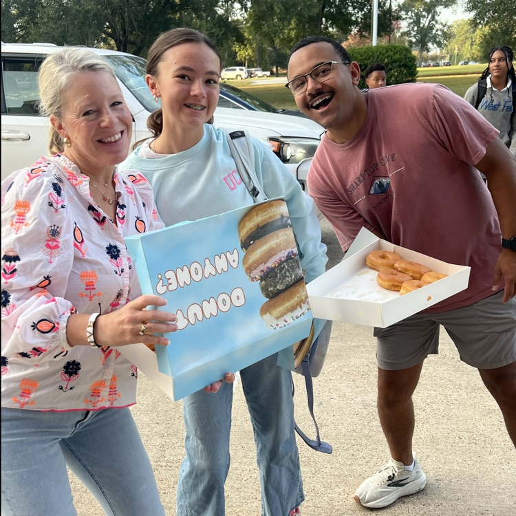 WyldLife leaders pass out donuts to students