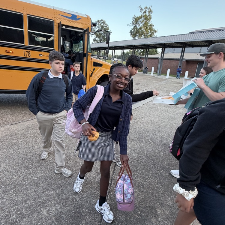 WyldLife leaders pass out donuts to students