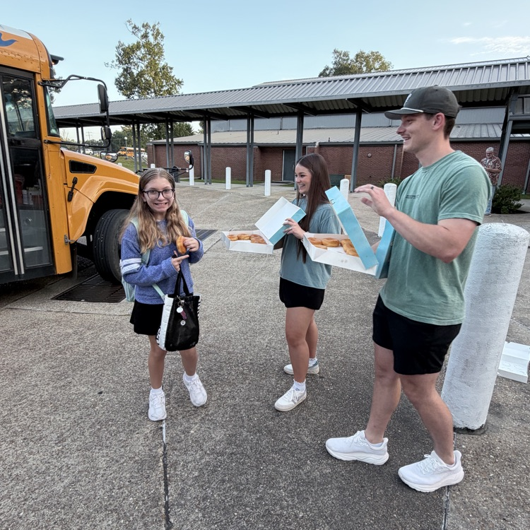 WyldLife leaders pass out donuts to students