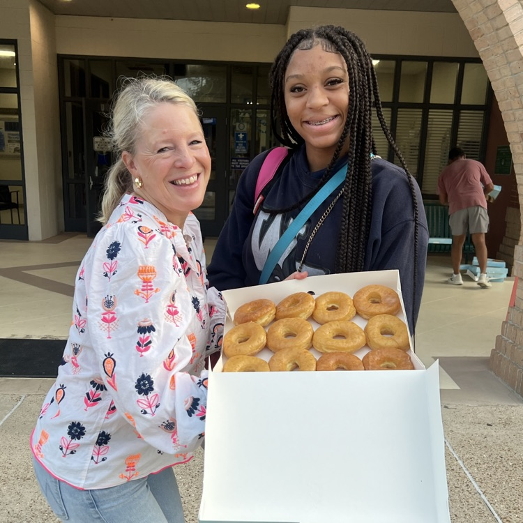 WyldLife leaders pass out donuts to students
