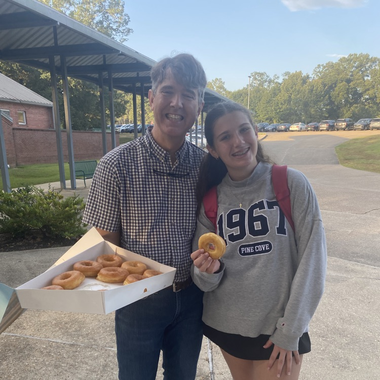 WyldLife leaders pass out donuts to students