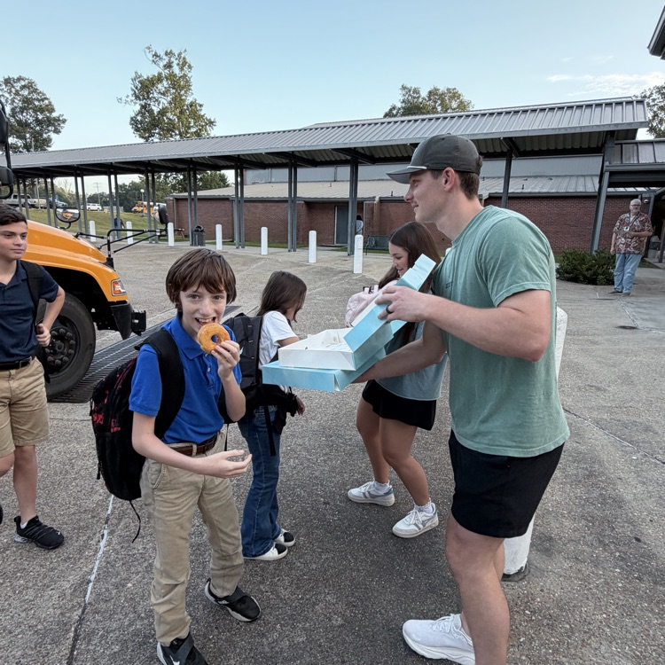 WyldLife leaders pass out donuts to students