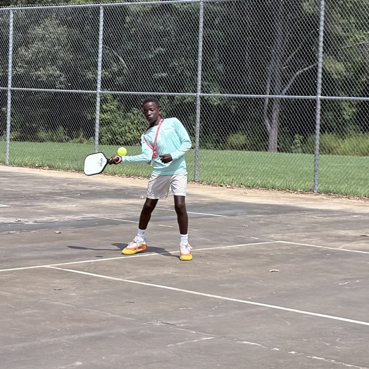 student plays pickle ball