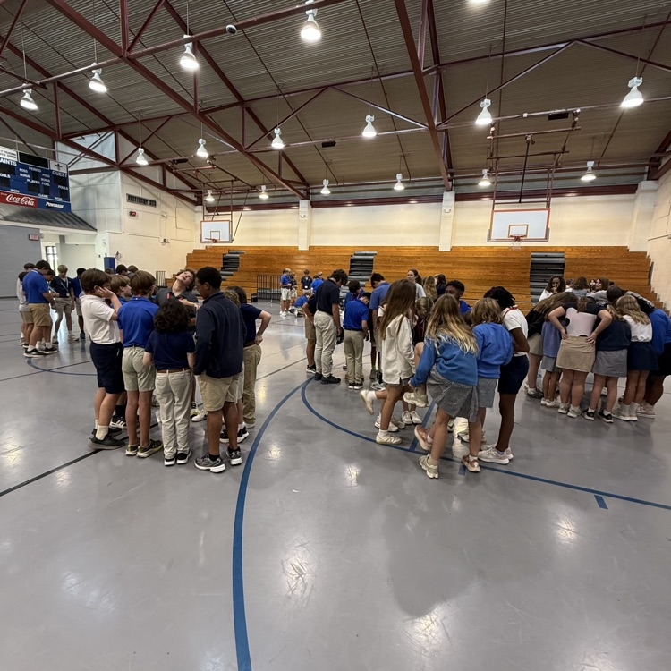 students pictured in groups in the gym
