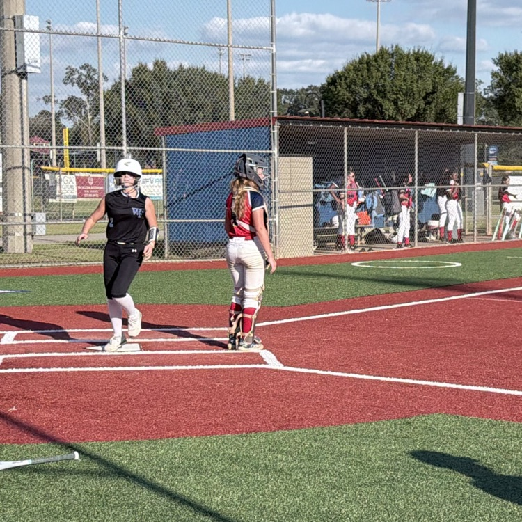 girl crosses home plate