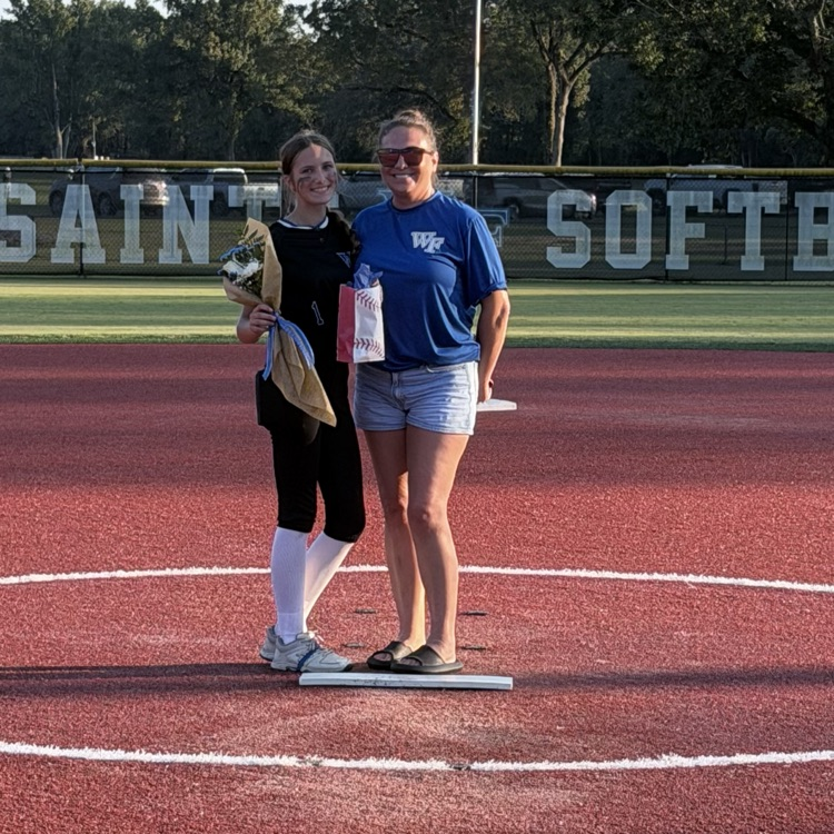 8th grade player poses with parent for last home game 