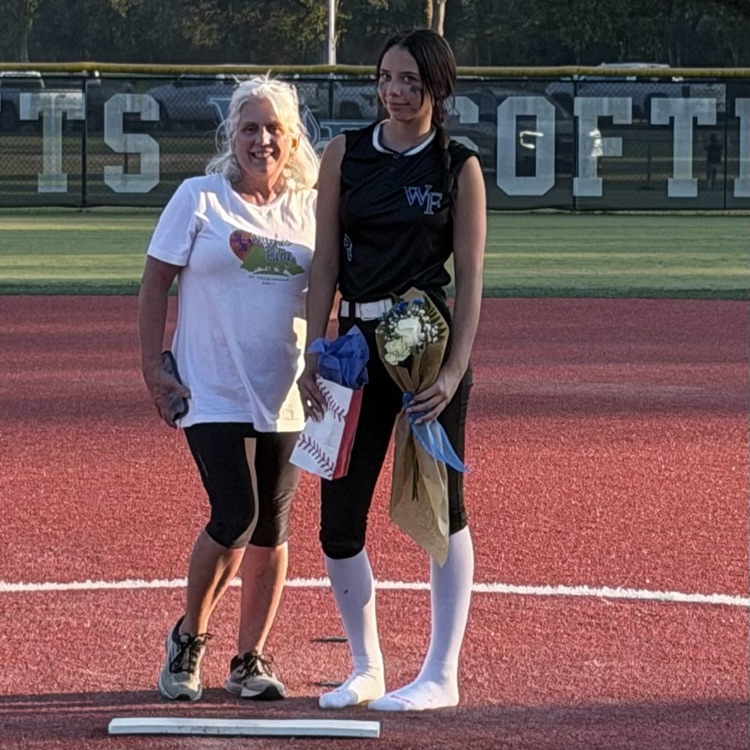 8th grade player poses with parent for last home game 