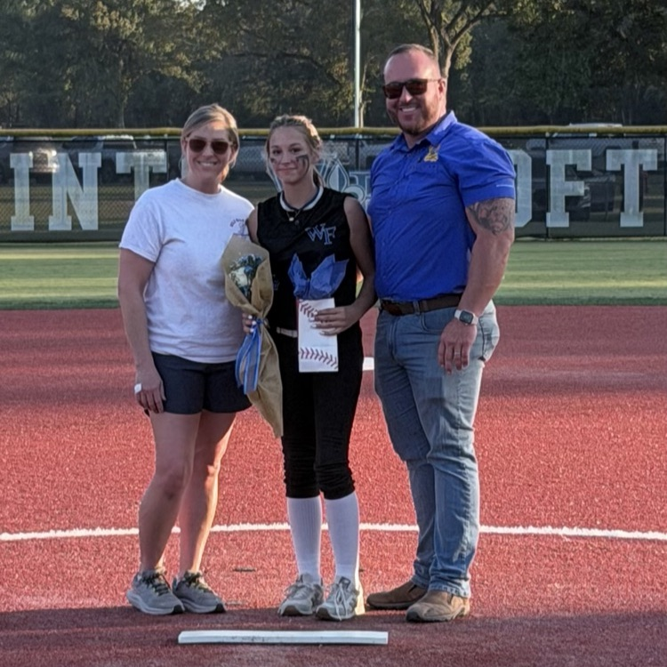 8th grade player poses with parent for last home game 