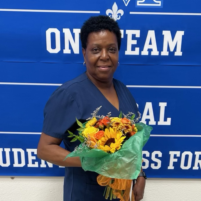 Ms. Gaines pictured with flowers