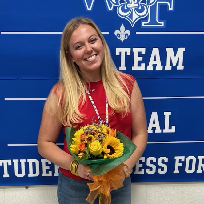 Ms. McKinney pictured holding flowers