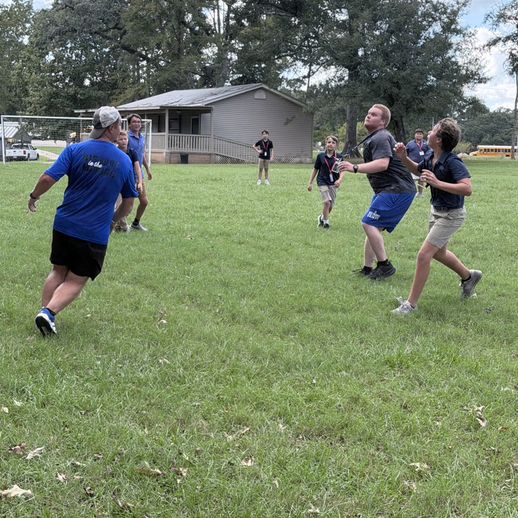 students and teachers play frisbee golf