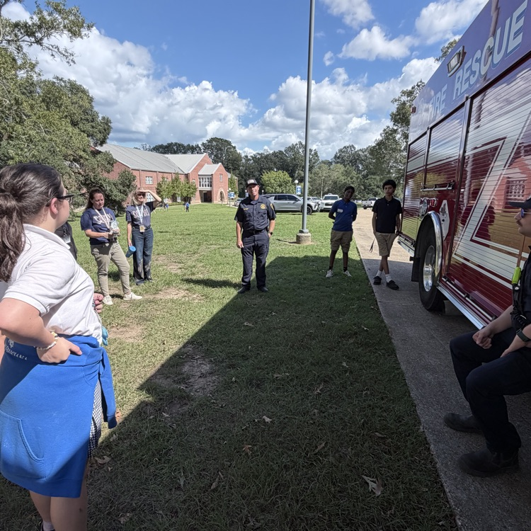 students listen to presentation from fire chief