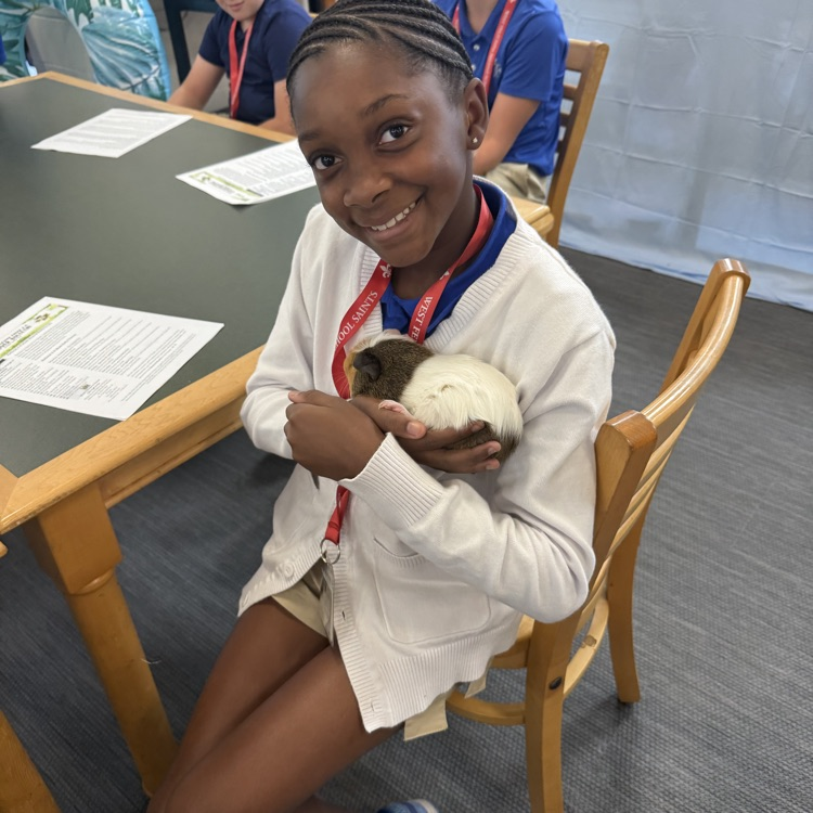 student holds a guinea pig