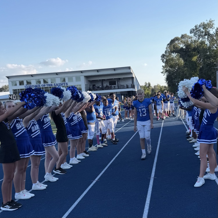 8th grade student athlete walks through cheer tunnel