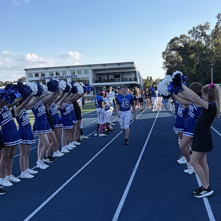 8th grade student athlete walks through cheer tunnel